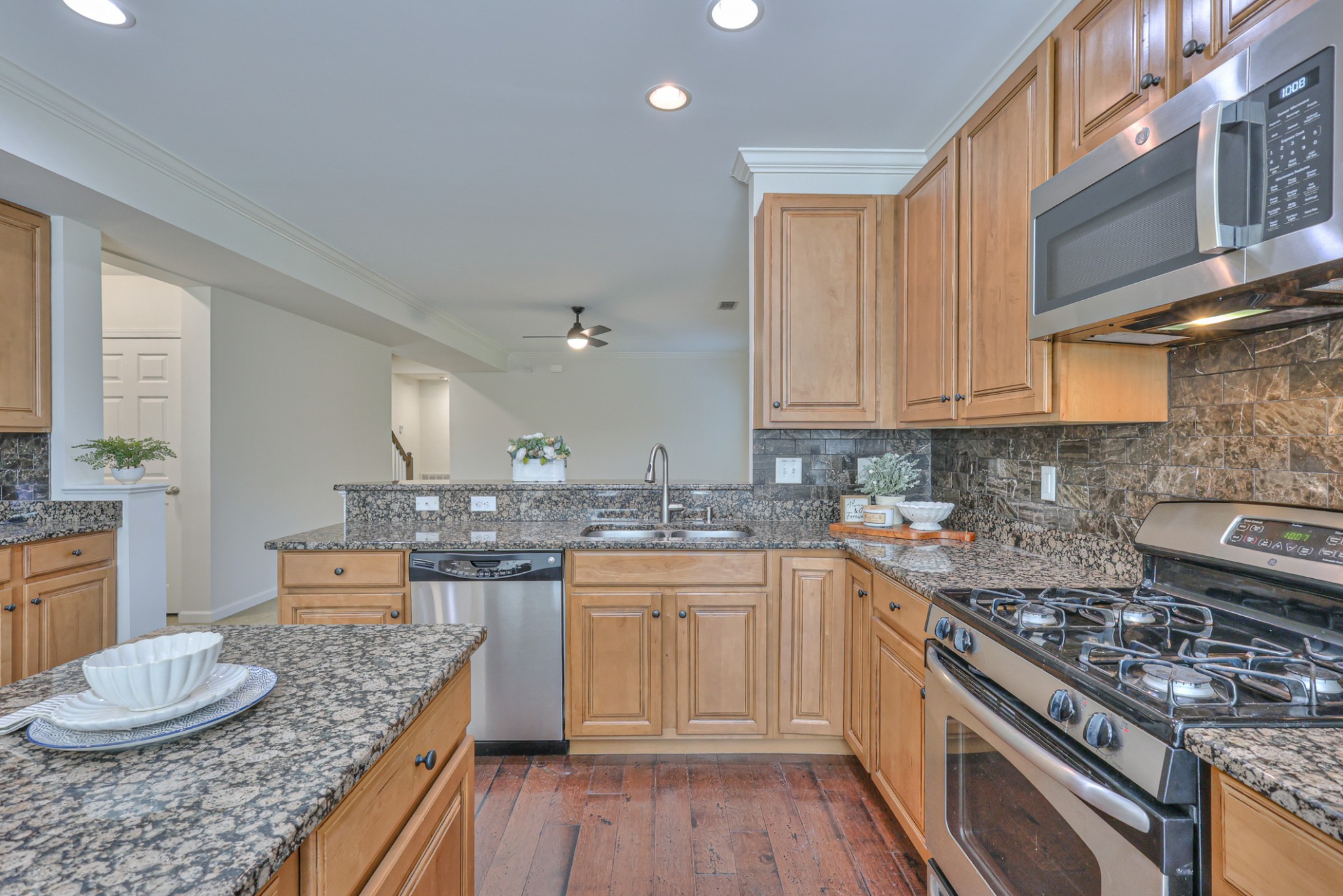 3104 Rutgers Pass Nolensville, TN 37135 - Photo 20 of 66 a kitchen with stainless steel appliances granite countertop a stove top oven a sink dishwasher and cabinets with wooden floor