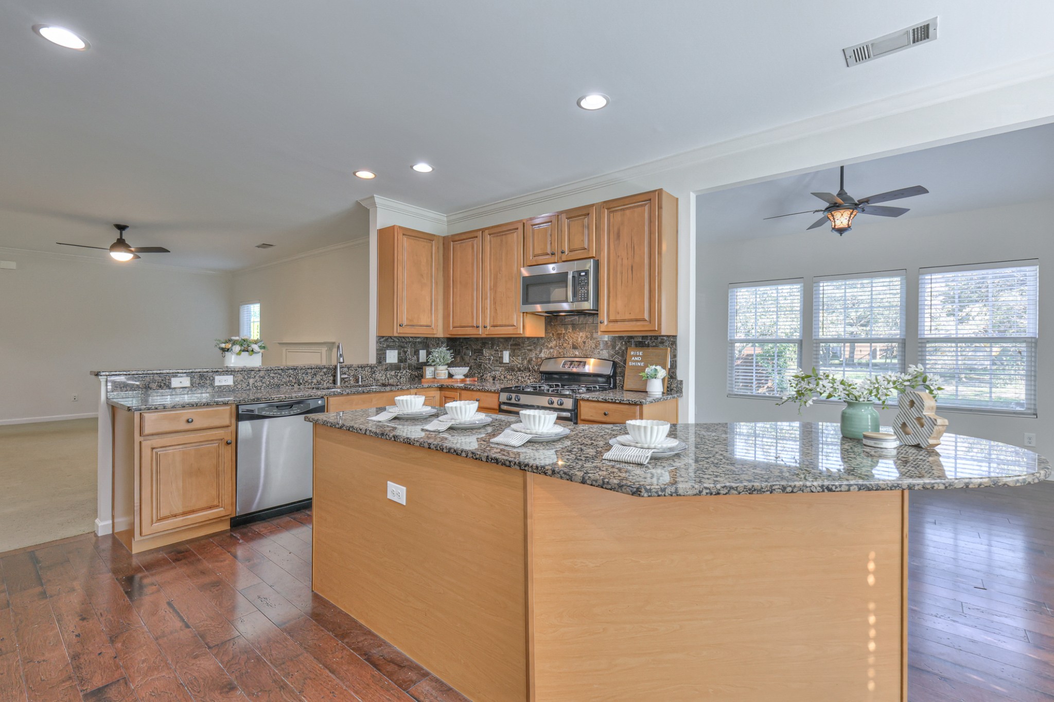 3104 Rutgers Pass Nolensville, TN 37135 - Photo 22 of 66 a kitchen with kitchen island granite countertop wooden cabinets a counter top space and a sink