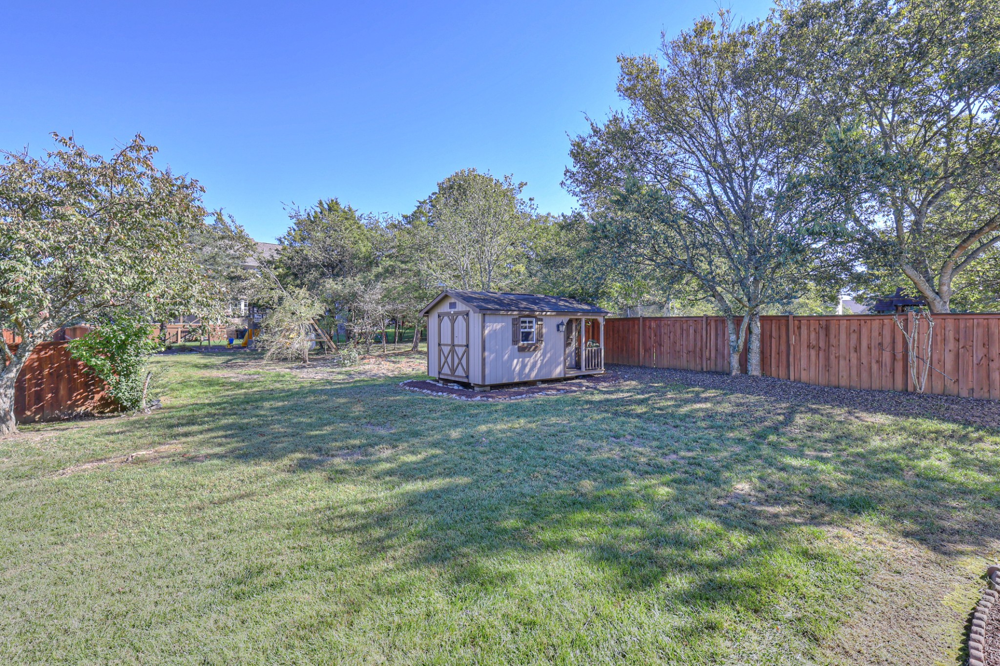3104 Rutgers Pass Nolensville, TN 37135 - Photo 58 of 66 a view of a backyard with large trees and wooden fence