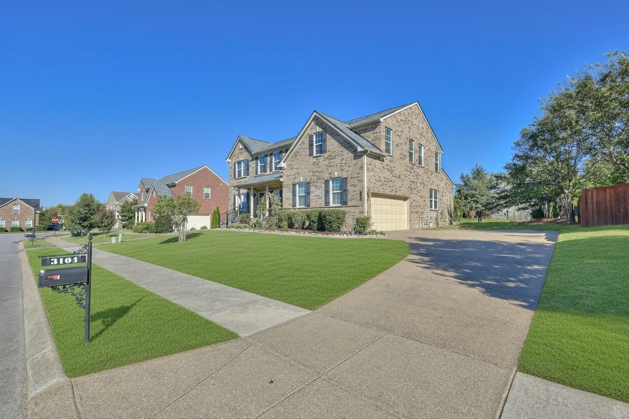 3104 Rutgers Pass Nolensville, TN 37135 - Photo 6 of 66 a front view of a house with a yard and garage