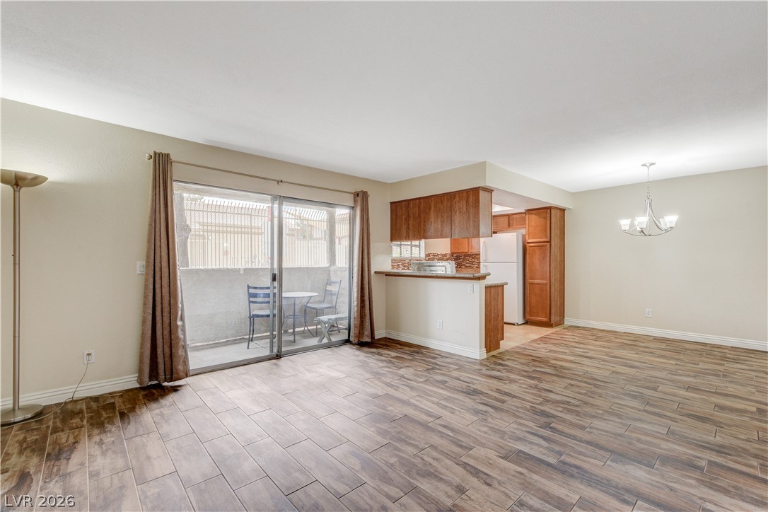 7200 West Pirates Cove Road, Unit 1026 Las Vegas, NV 89145 - Photo 4 of 35 This versatile living area transitions seamlessly into an inviting kitchen.