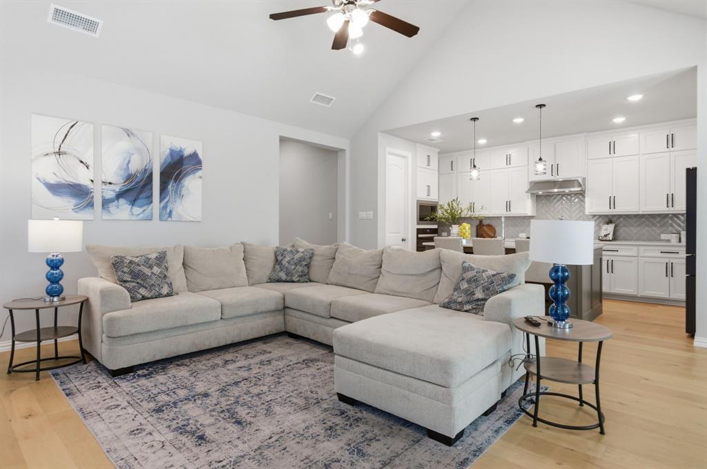 910 Winter Cherry Lane Haslet, TX 76052 - Photo 13 of 40 a living room with furniture and a chandelier