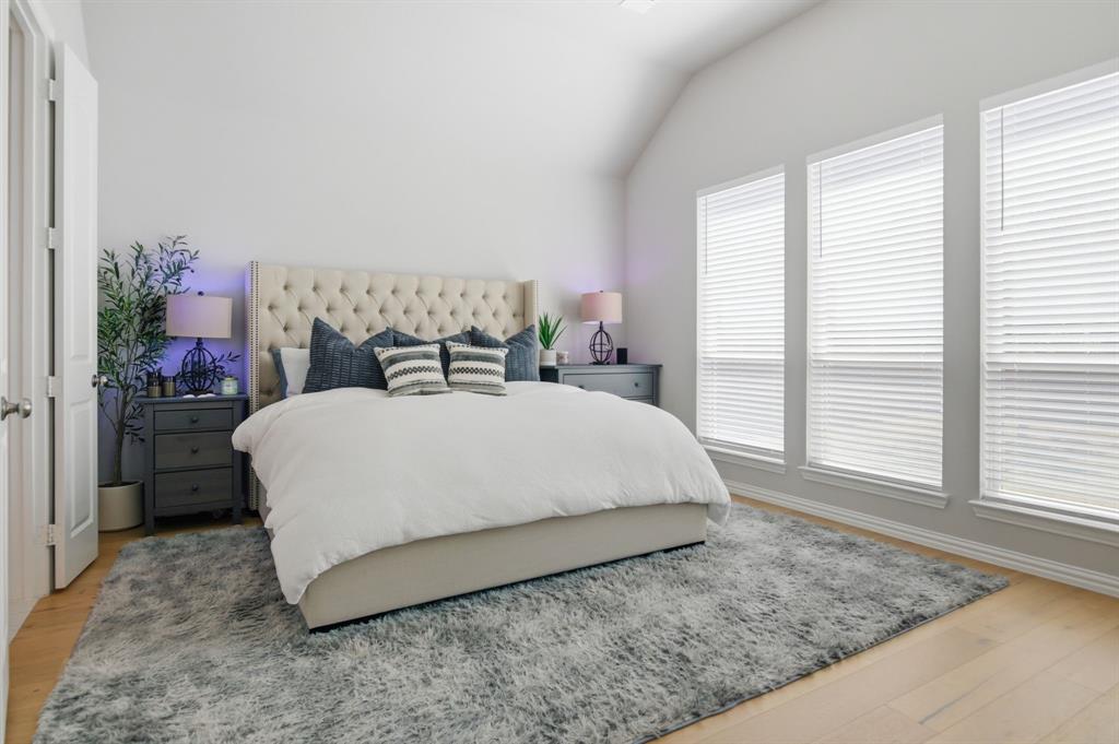 910 Winter Cherry Lane Haslet, TX 76052 - Photo 19 of 40 a large bed sitting in a bedroom next to a window