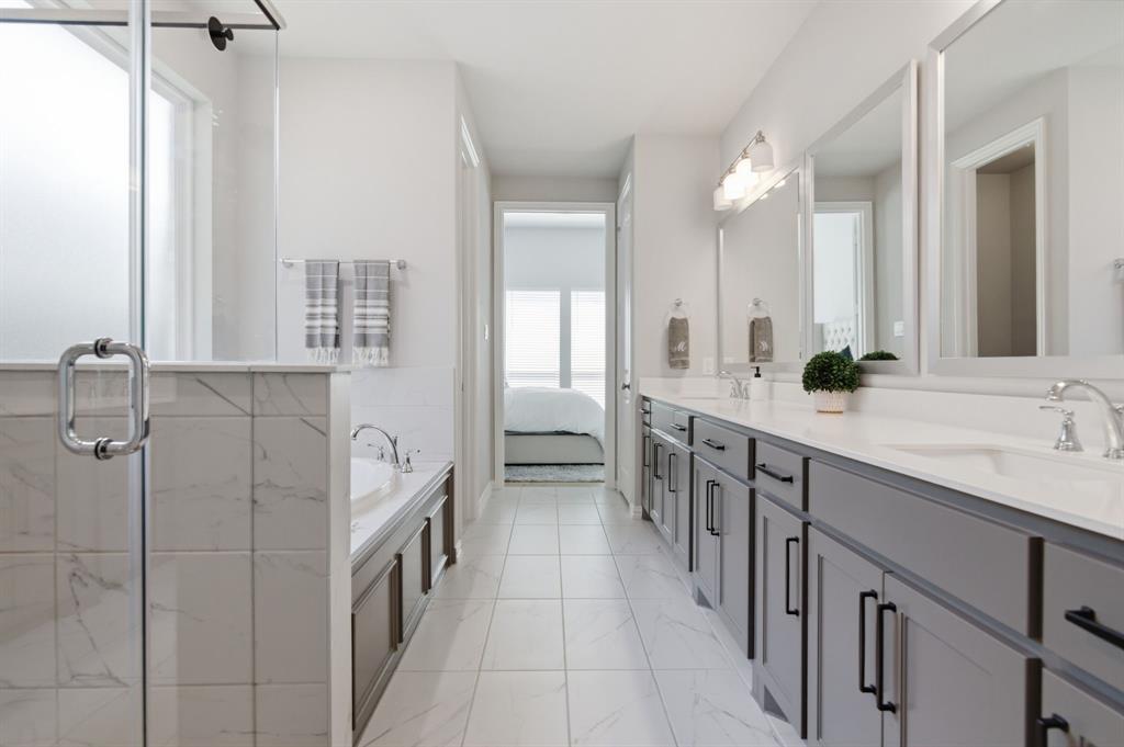 910 Winter Cherry Lane Haslet, TX 76052 - Photo 23 of 40 a bathroom with double vanity and mirrors