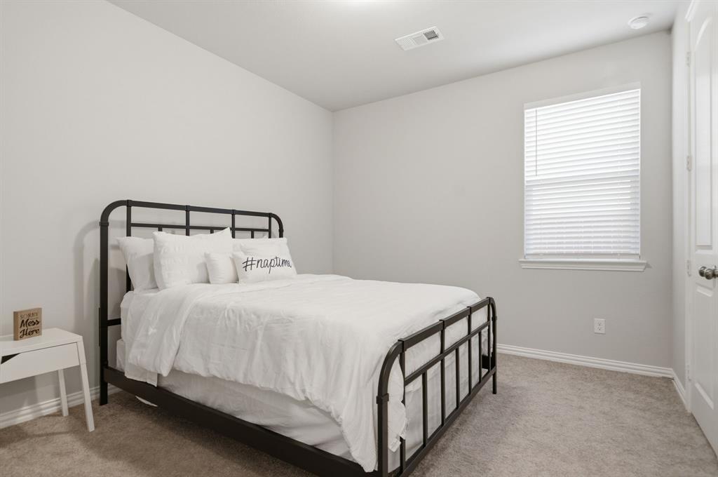 910 Winter Cherry Lane Haslet, TX 76052 - Photo 24 of 40 a bedroom with a bed and a window