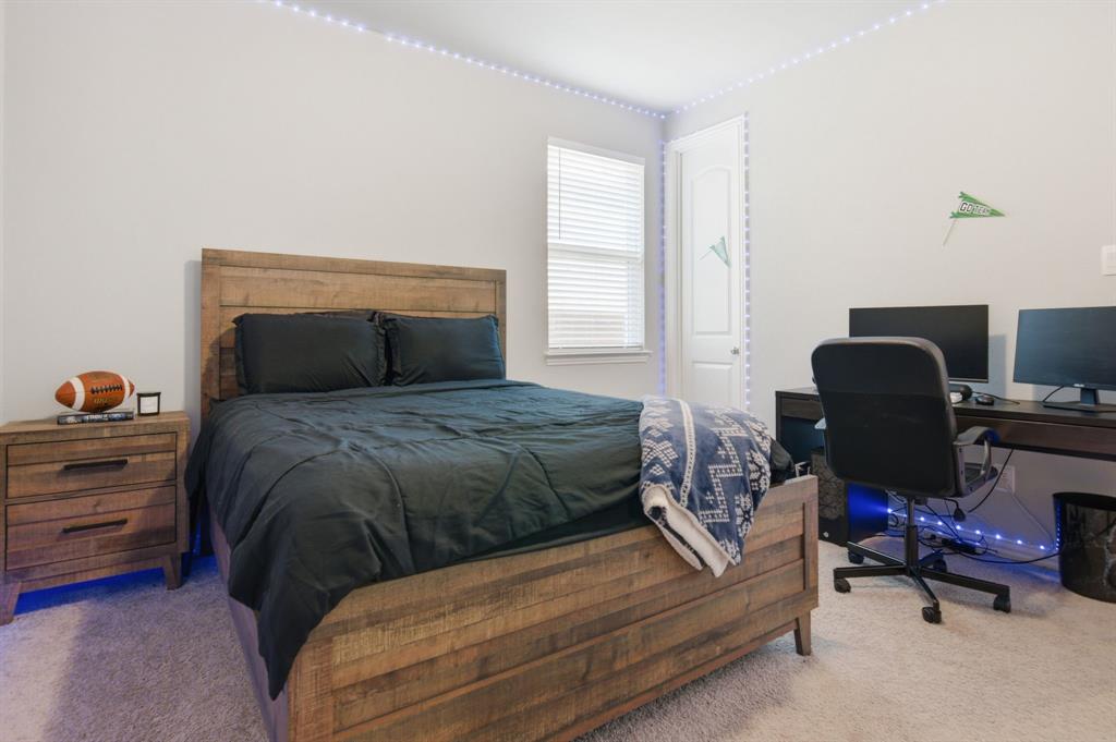 910 Winter Cherry Lane Haslet, TX 76052 - Photo 30 of 40 a bedroom with a bed and a chair
