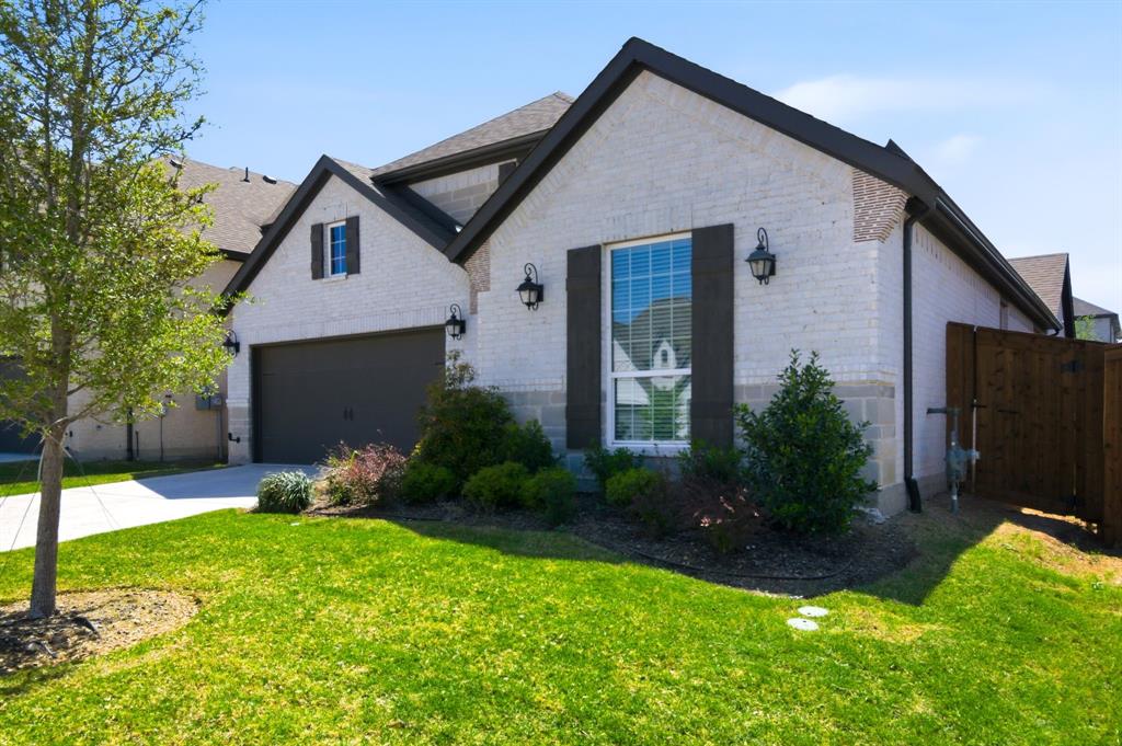 910 Winter Cherry Lane Haslet, TX 76052 - Photo 3 of 40 a front view of a house with a yard and garage
