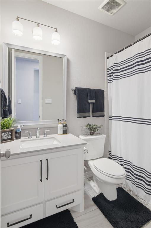 910 Winter Cherry Lane Haslet, TX 76052 - Photo 31 of 40 a bathroom with a sink a toilet a mirror and shower