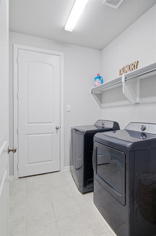 910 Winter Cherry Lane Haslet, TX 76052 - Photo 32 of 40 a utility room with dryer and washer