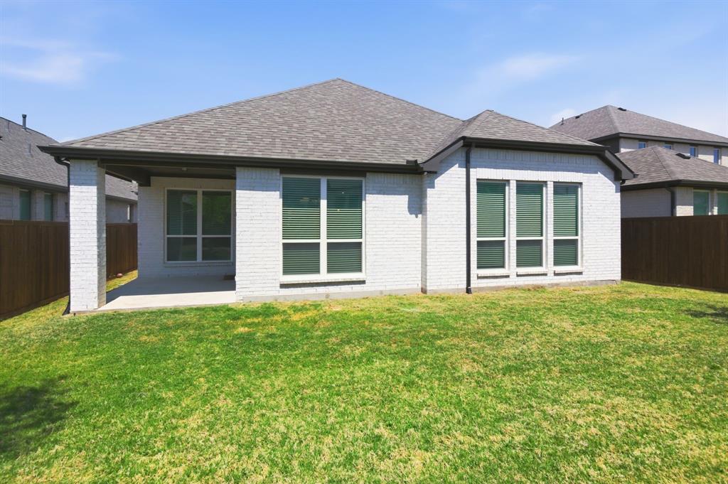 910 Winter Cherry Lane Haslet, TX 76052 - Photo 36 of 40 front view of a brick house with a yard