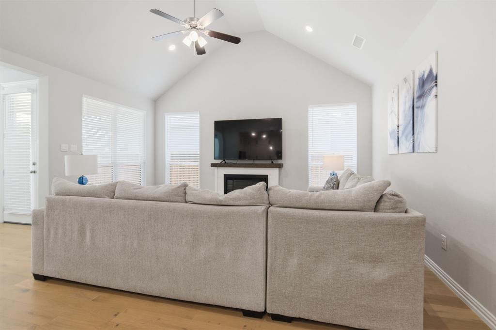 910 Winter Cherry Lane Haslet, TX 76052 - Photo 10 of 40 a living room with furniture and a flat screen tv