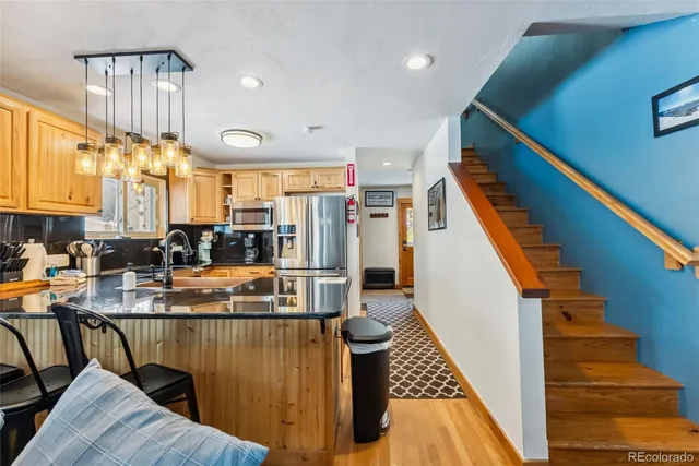 a view of a kitchen with furniture and staircase