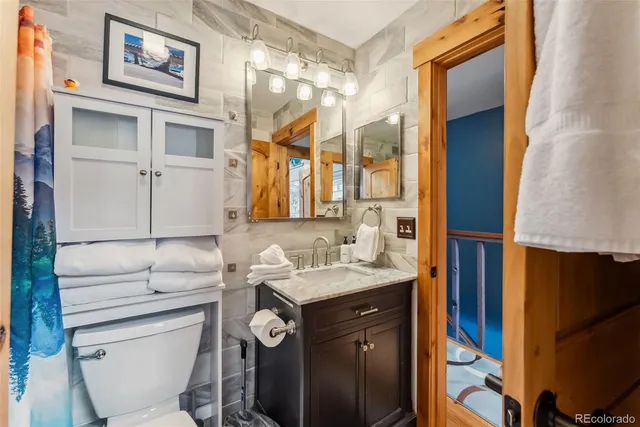 a bathroom with a sink toilet and mirror
