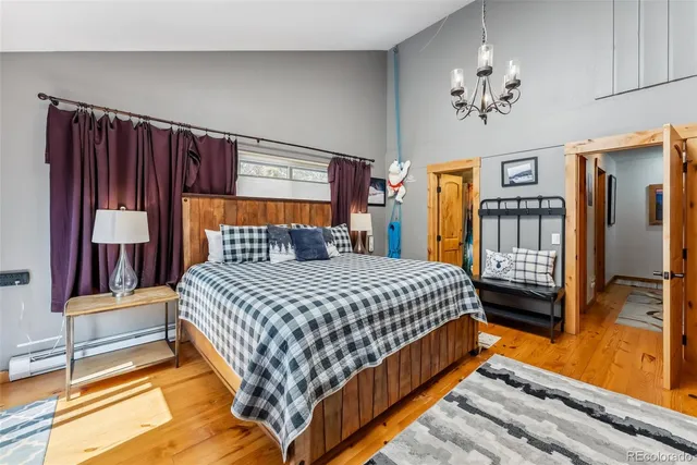 a bedroom with a bed and a chandelier