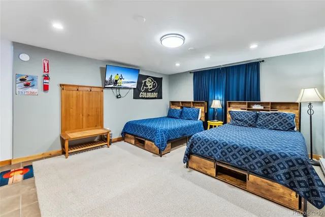 a bedroom with two beds and a window