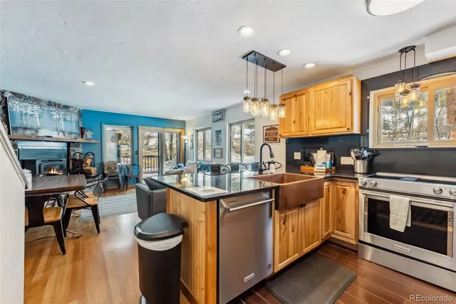 a kitchen with stainless steel appliances granite countertop a stove and cabinets