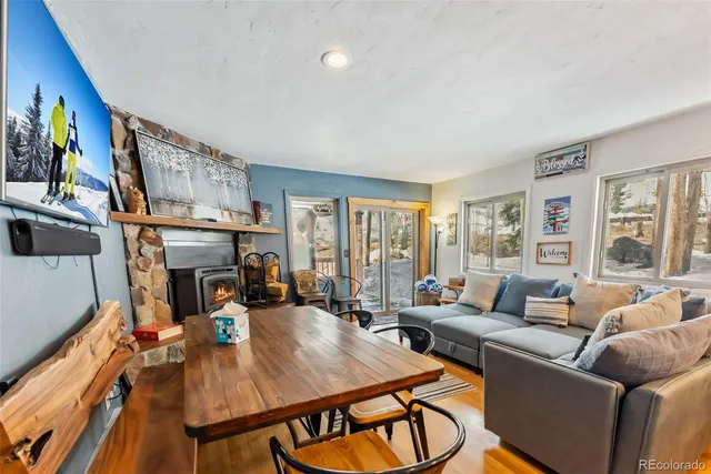 a living room with furniture fireplace and a large window