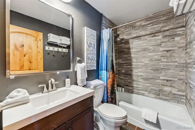 a bathroom with a sink toilet tub and shower