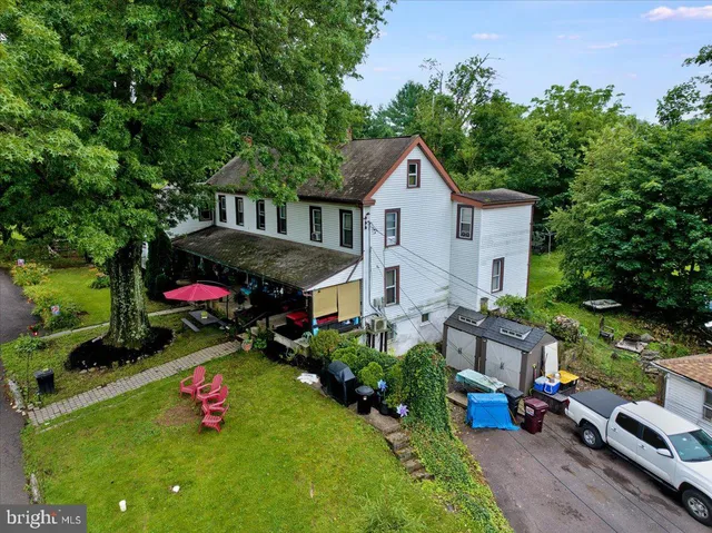 a view of a house with a yard and sitting area