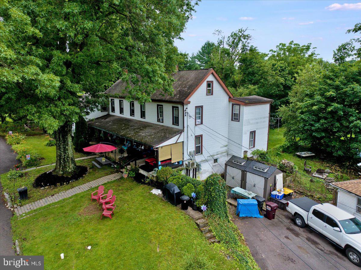 a view of a house with a yard and sitting area
