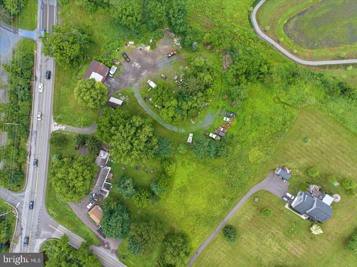 3854-3856 Schuylkill Road Spring City, PA 19475 - Photo 18 of 22 a backyard of a house with lots of green space and garden