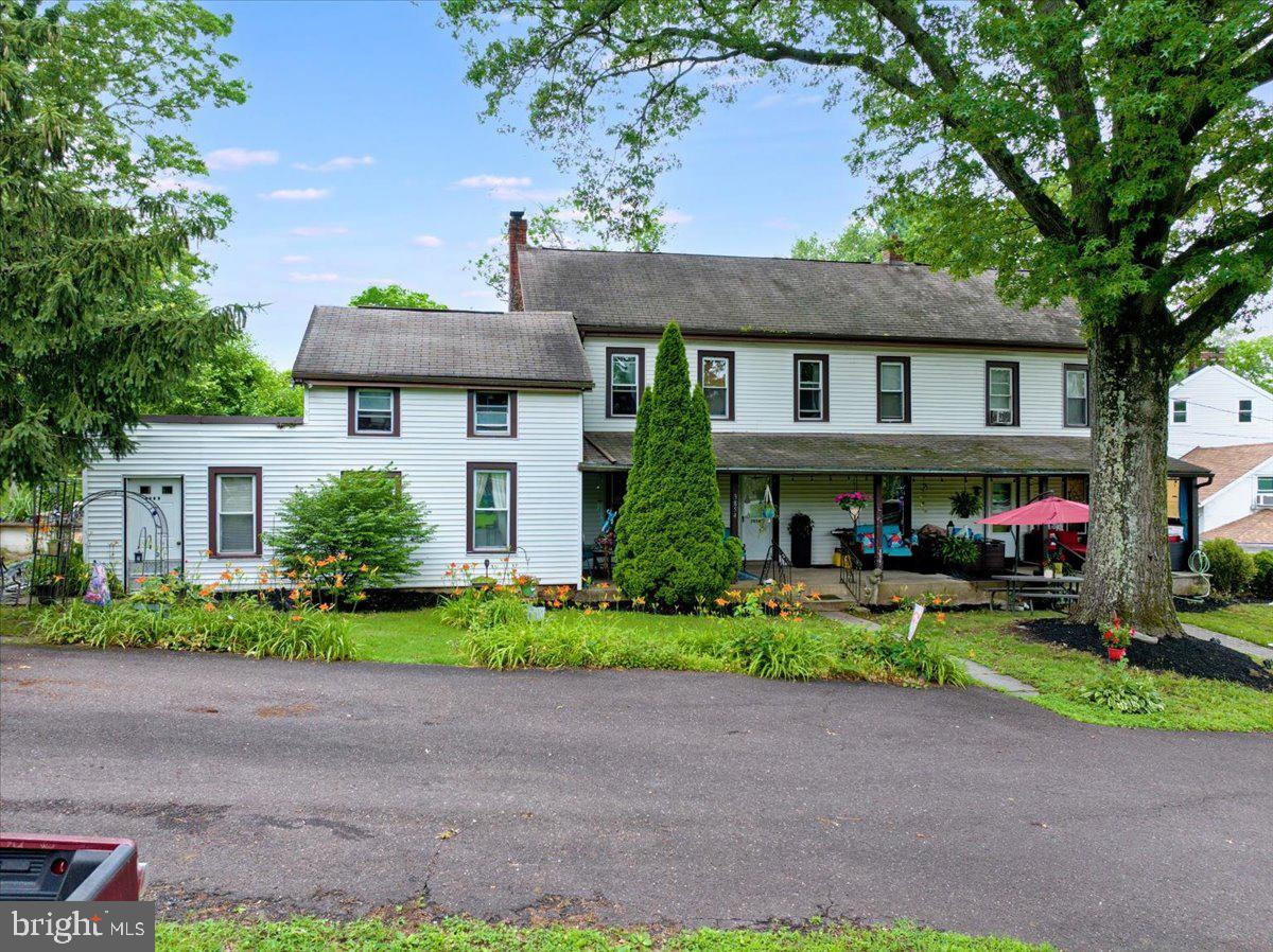 3854-3856 Schuylkill Road Spring City, PA 19475 - Photo 5 of 22 a front view of a house with a garden and trees