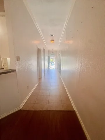 a view of a kitchen with a sink and wooden floor
