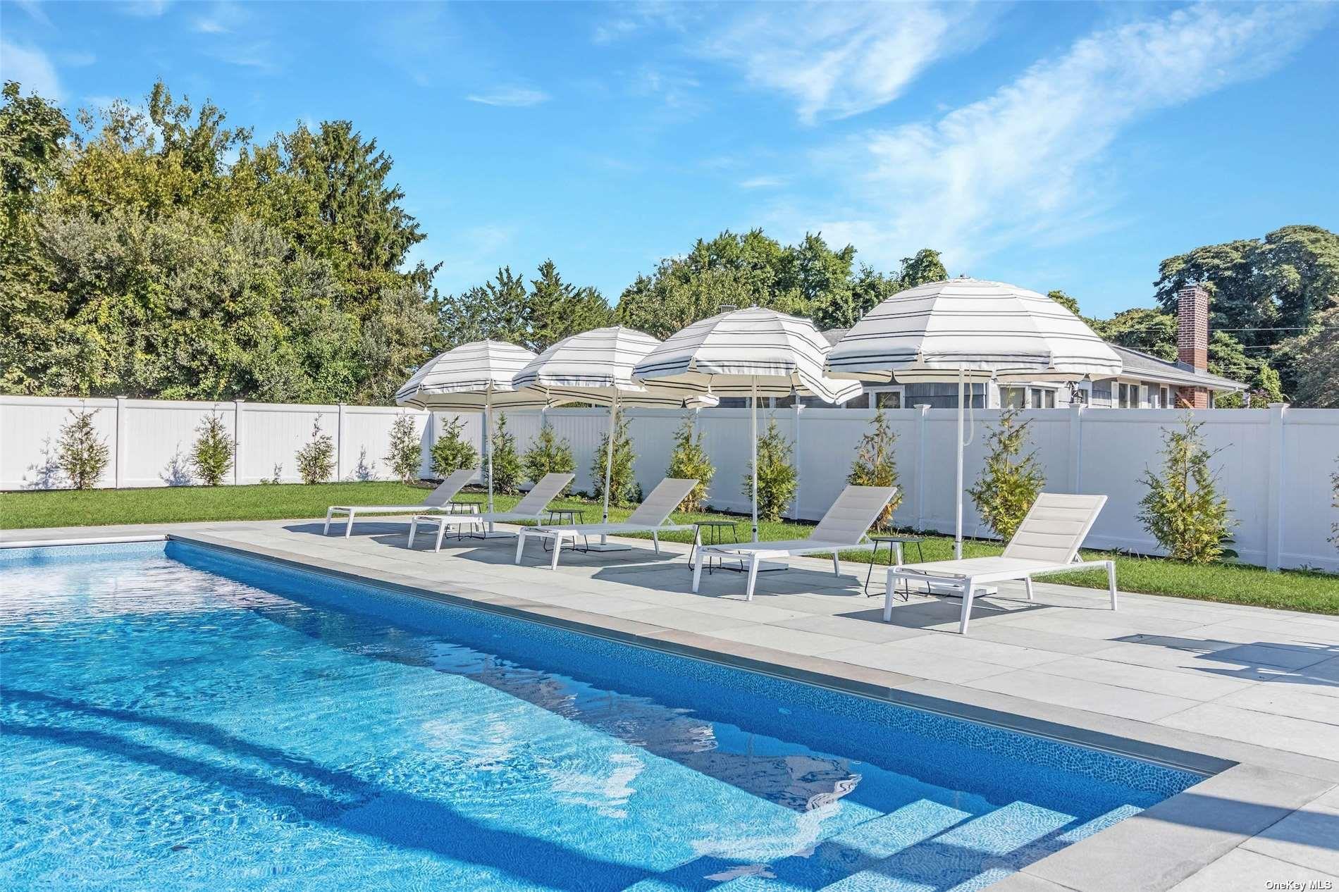 a view of a house with swimming pool and sitting area