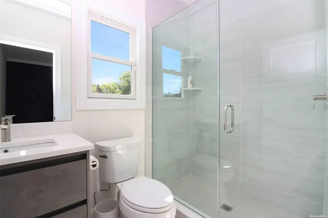 a white toilet sitting next to a bathroom sink