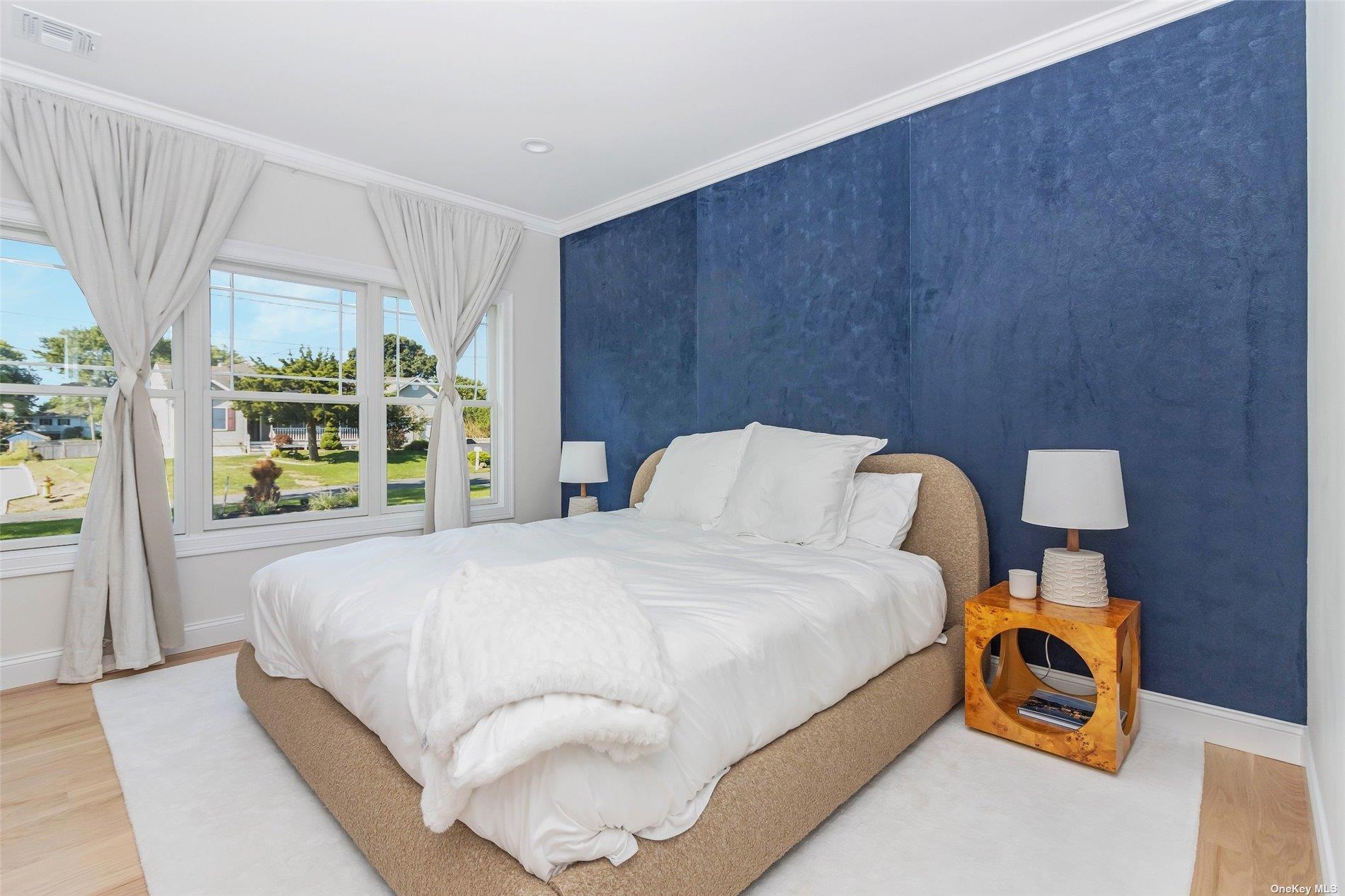 950 Tasker Lane Greenport, NY 11944 - Photo 14 of 37 a bedroom with a bed and a window