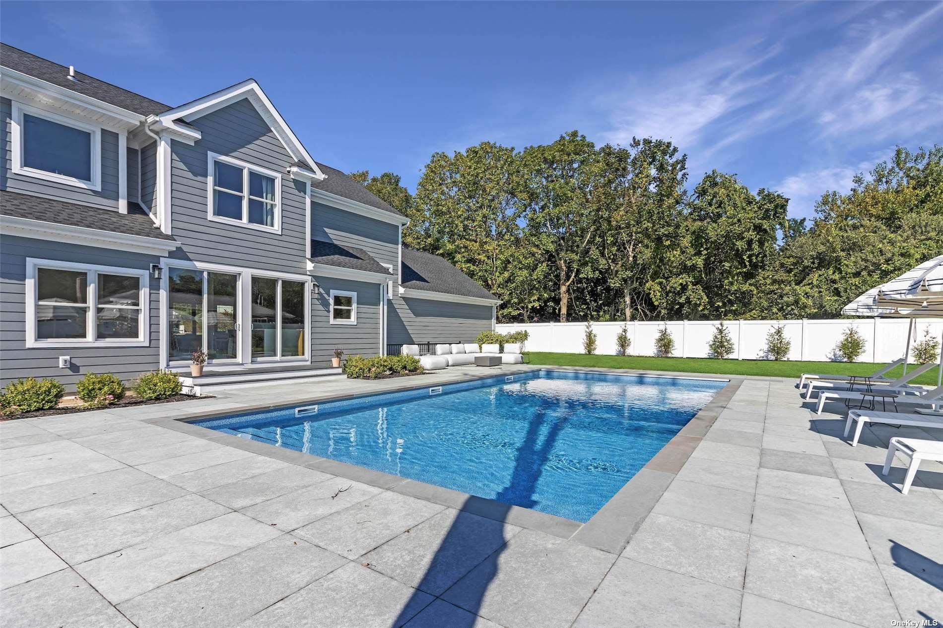 950 Tasker Lane Greenport, NY 11944 - Photo 16 of 37 a view of a swimming pool with a lounge chairs