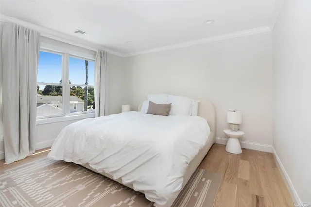 a large white bed in a white room