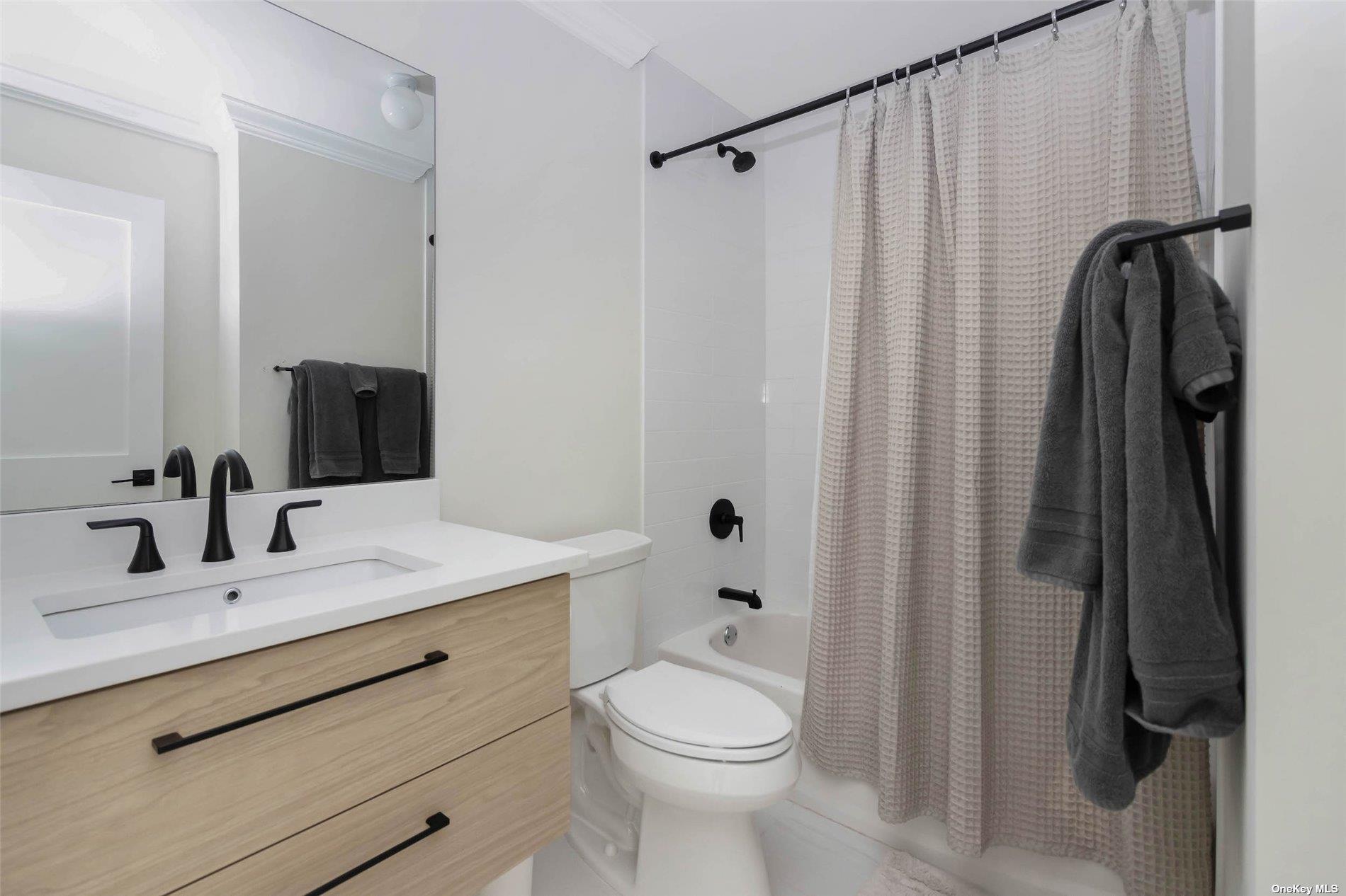950 Tasker Lane Greenport, NY 11944 - Photo 19 of 37 a bathroom with a sink a toilet and shower