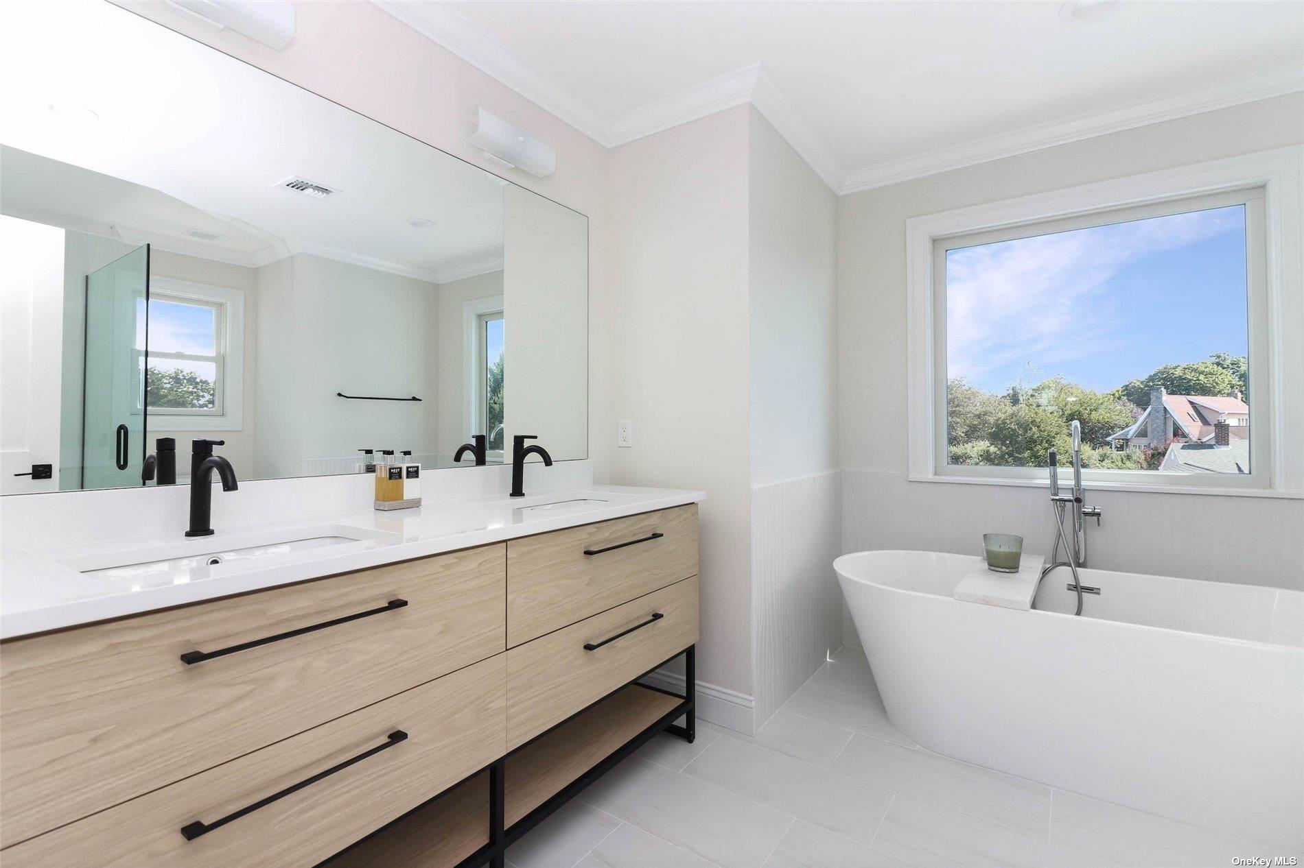 950 Tasker Lane Greenport, NY 11944 - Photo 25 of 37 a bathroom with a double vanity sink and a window
