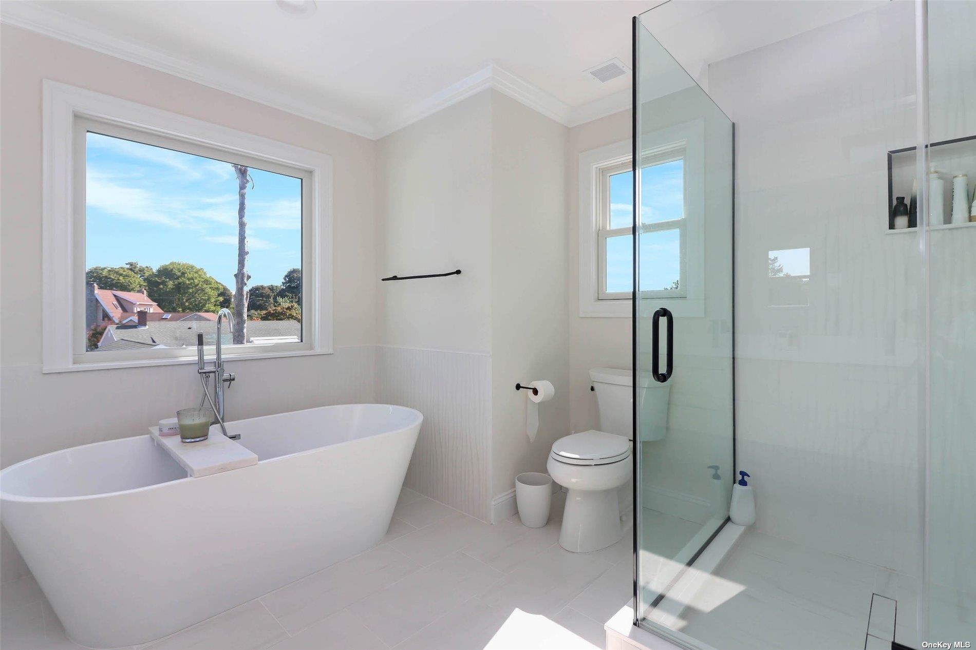 950 Tasker Lane Greenport, NY 11944 - Photo 27 of 37 a bathroom with a sink and a large mirror