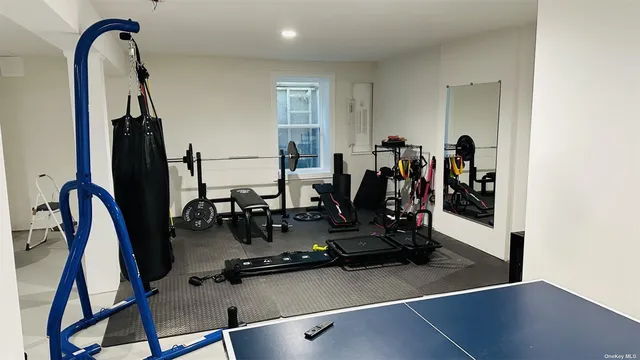 a room with gym equipment and large mirror