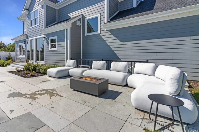 a view of a patio with couches and a potted plant on a street