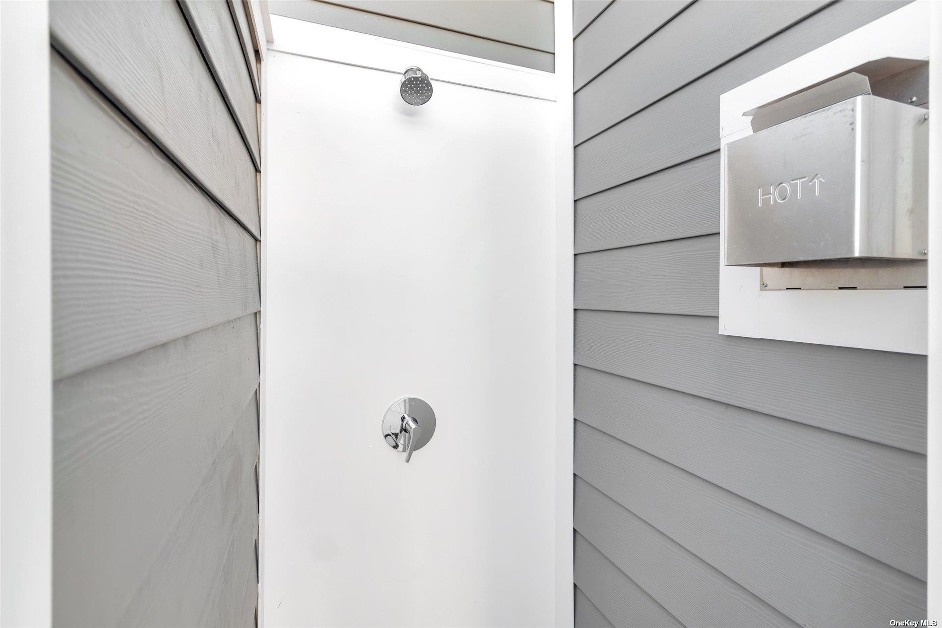 950 Tasker Lane Greenport, NY 11944 - Photo 32 of 37 a bathroom with a shower and a mirror