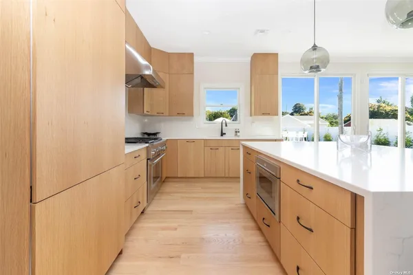 a kitchen with kitchen island granite countertop a sink a center island and cabinets