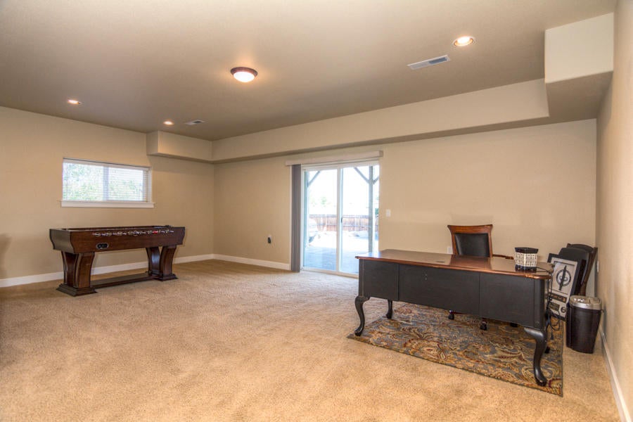 2159 Southwest 36th Court Redmond, OR 97756 - Photo 33 of 44 Lower level media room with slider leading to covered patio.