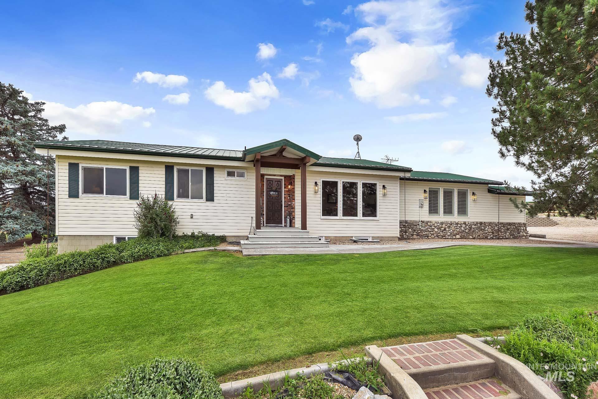 16871 Boehner Road Caldwell, ID 83607 - Photo 1 of 1 Ranch-style house with a front yard and a metal roof