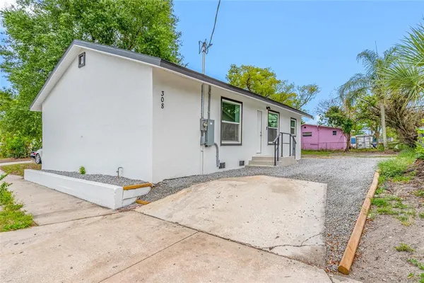 a view of a house with a backyard and a garage