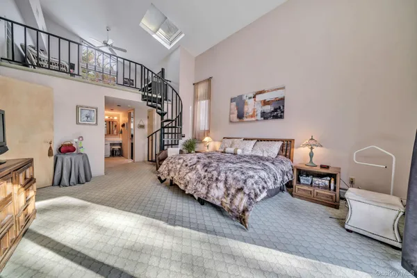 a bedroom with a bed a couch and dresser