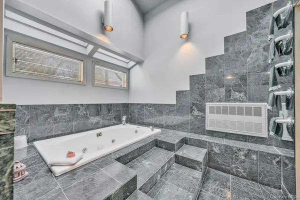 a bathroom with a bathtub and a shower