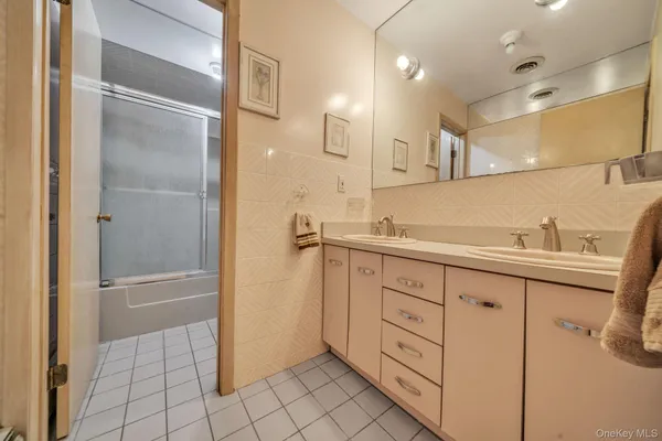 a bathroom with a sink a mirror and a shower