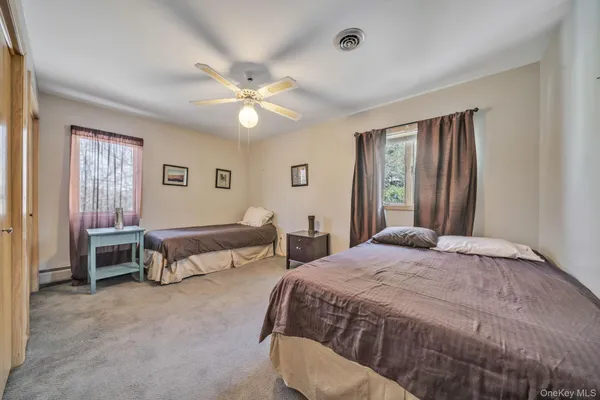 a spacious bedroom with a bed and a chandelier