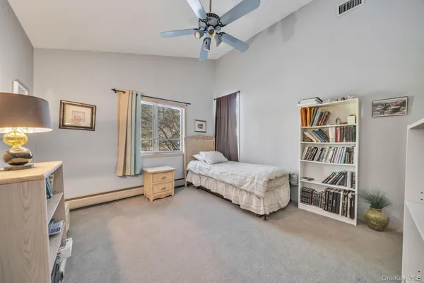 a spacious bedroom with a bed and a cabinets
