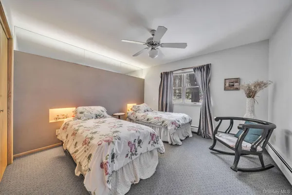 a bedroom with two beds and window