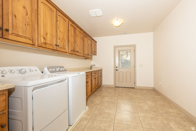 888 East Fiddlers Canyon Road Cedar City, UT 84721 - Photo 43 of 74 Laundry room with washing machine and clothes dryer, light tile patterned floors, and cabinet space