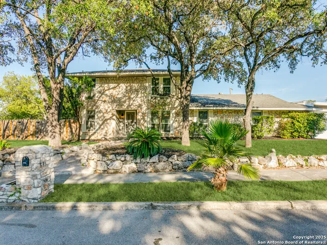 a front view of a house with a yard and outdoor seating